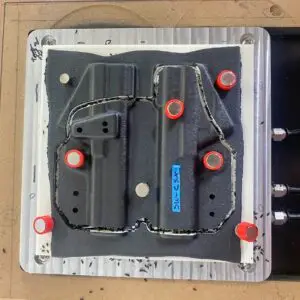 Holsters being trimmed on the CNC